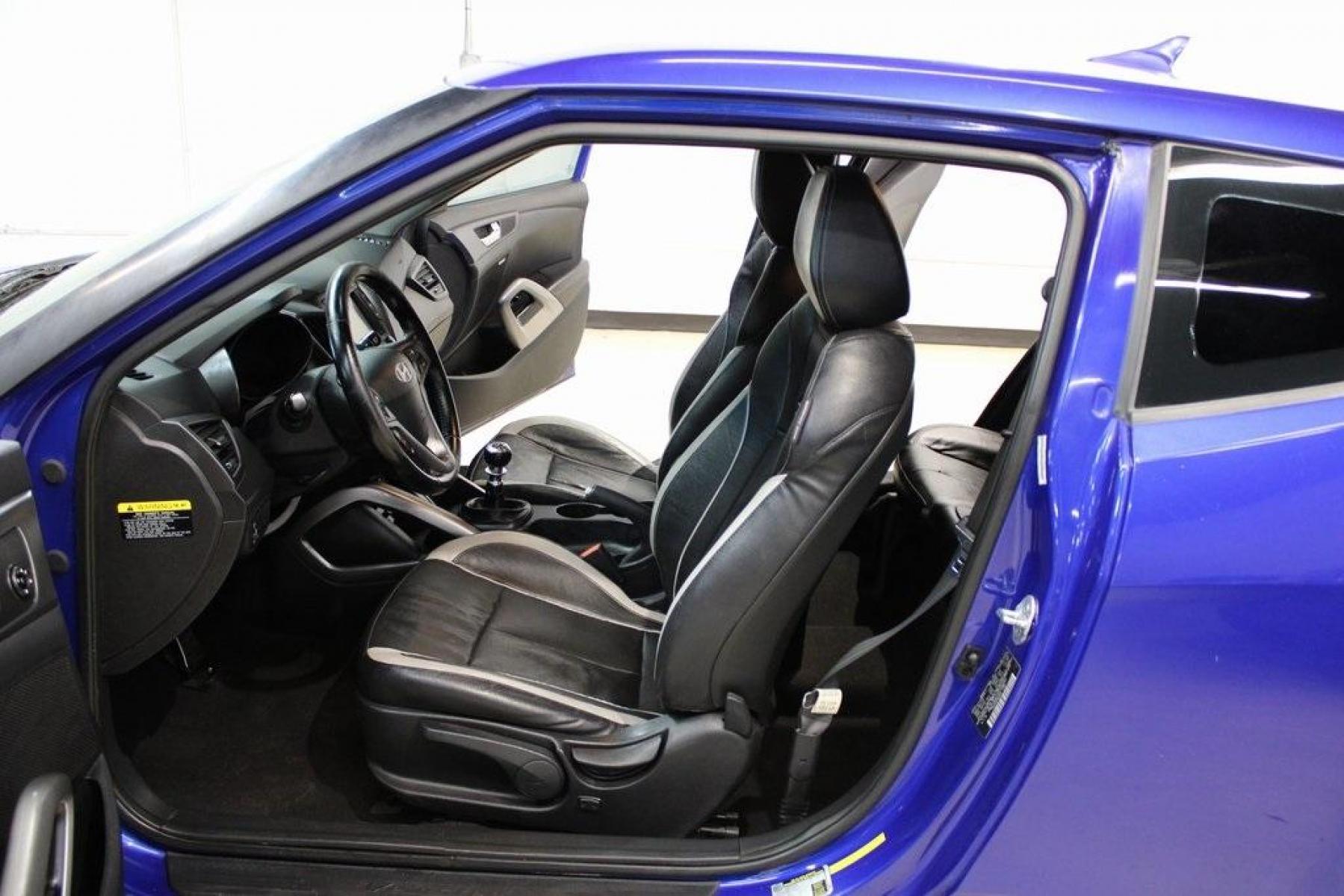 2014 Marathon Blue Pearl /Black Hyundai Veloster Turbo (KMHTC6AE7EU) with an 1.6L I4 DGI DOHC 16V Turbocharged engine, Manual transmission, located at 15300 Midway Rd., Addison, TX, 75001, (972) 702-0011, 32.958321, -96.838074 - HOME OF THE NO HAGGLE PRICE - WHOLESALE PRICES TO THE PUBLIC!! Veloster Turbo w/Black, 3D Hatchback, 1.6L I4 DGI DOHC 16V Turbocharged, 6-Speed Manual, FWD, Marathon Blue Pearl, Black Leather.<br><br>Marathon Blue Pearl 2014 Hyundai Veloster Turbo<br><br>Recent Arrival! 24/33 City/Highway MPG<br><br - Photo #12