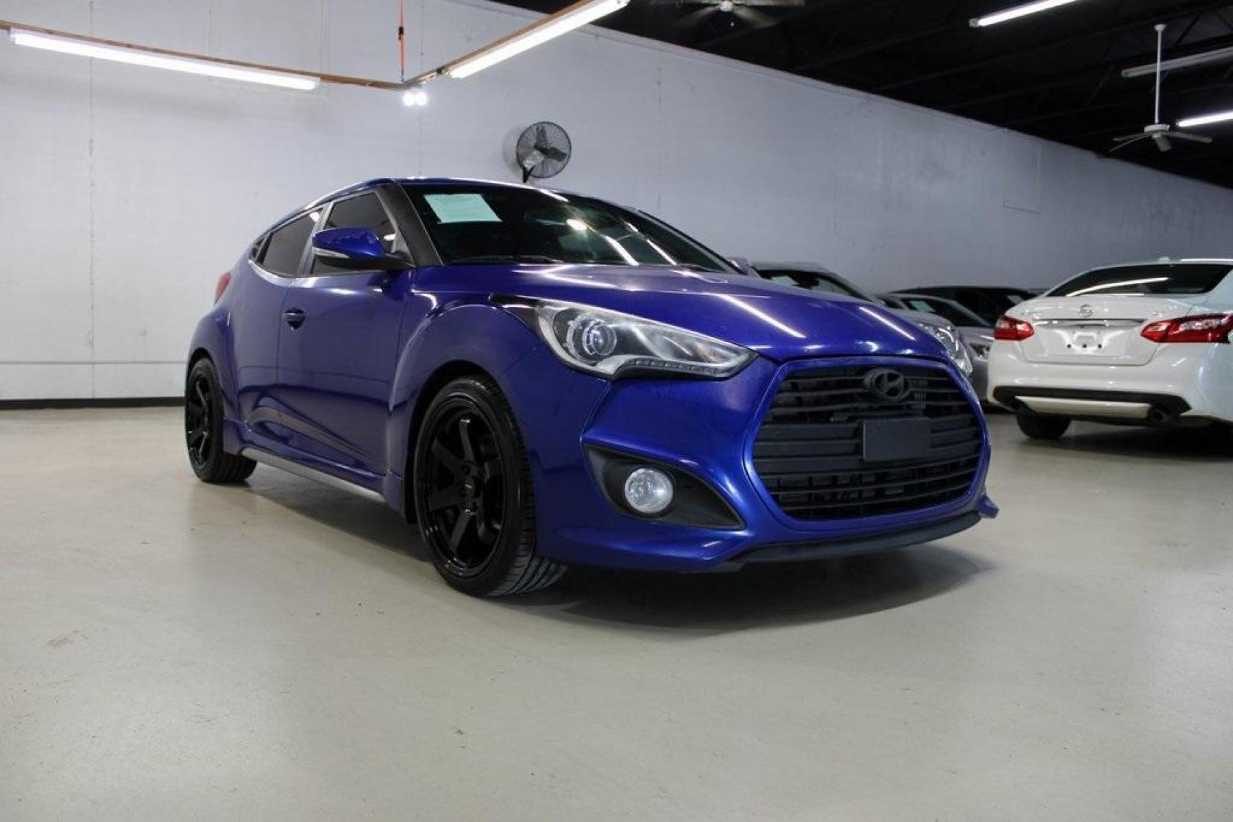 2014 Marathon Blue Pearl /Black Hyundai Veloster Turbo (KMHTC6AE7EU) with an 1.6L I4 DGI DOHC 16V Turbocharged engine, Manual transmission, located at 15300 Midway Rd., Addison, TX, 75001, (972) 702-0011, 32.958321, -96.838074 - HOME OF THE NO HAGGLE PRICE - WHOLESALE PRICES TO THE PUBLIC!! Veloster Turbo w/Black, 3D Hatchback, 1.6L I4 DGI DOHC 16V Turbocharged, 6-Speed Manual, FWD, Marathon Blue Pearl, Black Leather.<br><br>Marathon Blue Pearl 2014 Hyundai Veloster Turbo<br><br>Recent Arrival! 24/33 City/Highway MPG<br><br - Photo #1