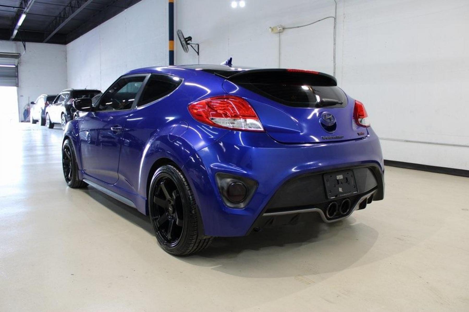 2014 Marathon Blue Pearl /Black Hyundai Veloster Turbo (KMHTC6AE7EU) with an 1.6L I4 DGI DOHC 16V Turbocharged engine, Manual transmission, located at 15300 Midway Rd., Addison, TX, 75001, (972) 702-0011, 32.958321, -96.838074 - HOME OF THE NO HAGGLE PRICE - WHOLESALE PRICES TO THE PUBLIC!! Veloster Turbo w/Black, 3D Hatchback, 1.6L I4 DGI DOHC 16V Turbocharged, 6-Speed Manual, FWD, Marathon Blue Pearl, Black Leather.<br><br>Marathon Blue Pearl 2014 Hyundai Veloster Turbo<br><br>Recent Arrival! 24/33 City/Highway MPG<br><br - Photo #3