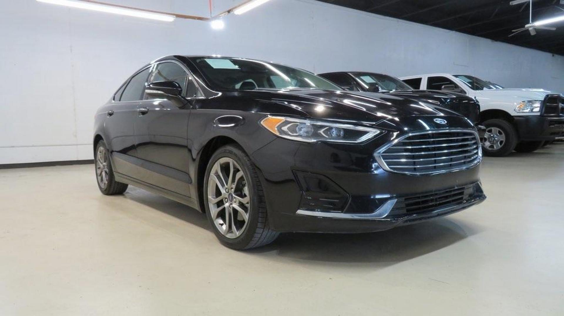 2020 Agate Black Metallic /Ebony Ford Fusion SEL (3FA6P0CD2LR) with an 1.5L EcoBoost engine, Automatic transmission, located at 15300 Midway Rd., Addison, TX, 75001, (972) 702-0011, 32.958321, -96.838074 - HOME OF THE NO HAGGLE PRICE - WHOLESALE PRICES TO THE PUBLIC!! Bluetooth, Hands Free Connectivity, Backup Camera, Leather Seats, Sunroof / Moonroof, NON SMOKER, Fusion SEL, 4D Sedan, 1.5L EcoBoost, 6-Speed Automatic, FWD, Black.<br><br>Black 2020 Ford Fusion SEL<br><br>23/34 City/Highway MPG<br><br> - Photo#1