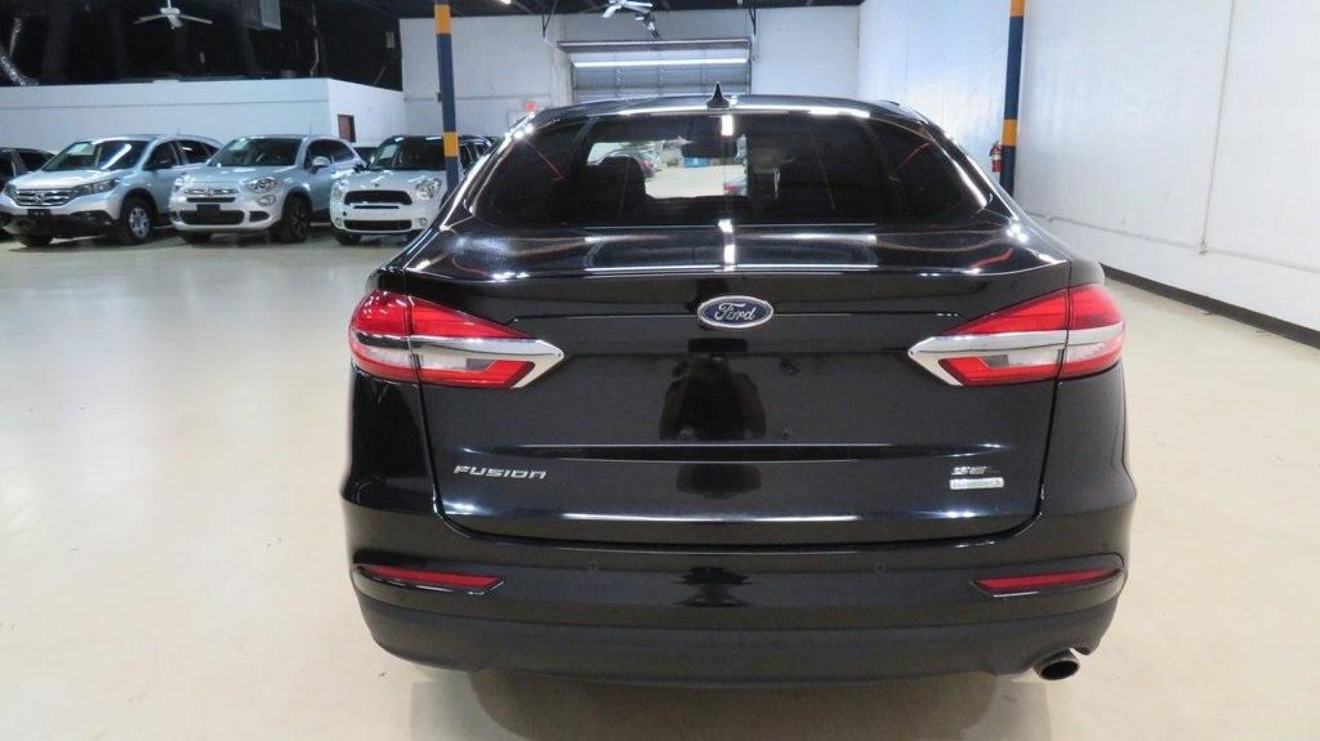 2020 Agate Black Metallic /Ebony Ford Fusion SEL (3FA6P0CD2LR) with an 1.5L EcoBoost engine, Automatic transmission, located at 15300 Midway Rd., Addison, TX, 75001, (972) 702-0011, 32.958321, -96.838074 - HOME OF THE NO HAGGLE PRICE - WHOLESALE PRICES TO THE PUBLIC!! Bluetooth, Hands Free Connectivity, Backup Camera, Leather Seats, Sunroof / Moonroof, NON SMOKER, Fusion SEL, 4D Sedan, 1.5L EcoBoost, 6-Speed Automatic, FWD, Black.<br><br>Black 2020 Ford Fusion SEL<br><br>23/34 City/Highway MPG<br><br> - Photo#7