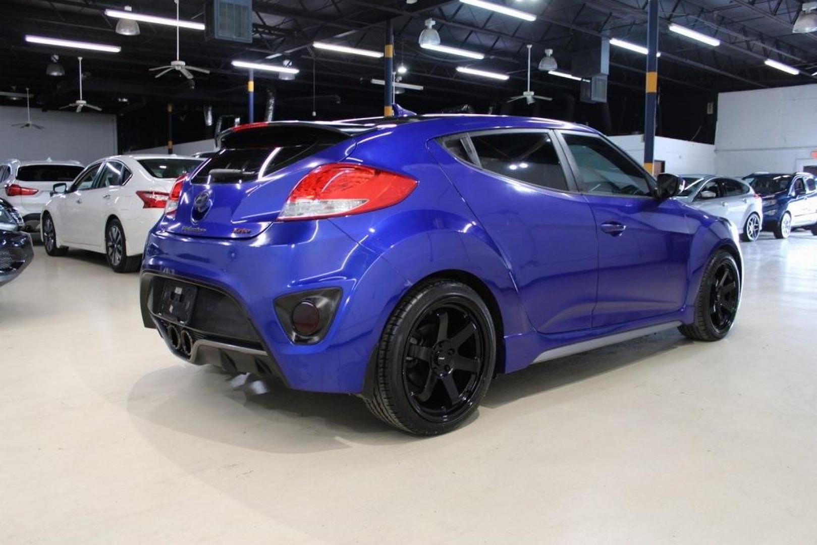 2014 Marathon Blue Pearl /Black Hyundai Veloster Turbo (KMHTC6AE7EU) with an 1.6L I4 DGI DOHC 16V Turbocharged engine, Manual transmission, located at 15300 Midway Rd., Addison, TX, 75001, (972) 702-0011, 32.958321, -96.838074 - HOME OF THE NO HAGGLE PRICE - WHOLESALE PRICES TO THE PUBLIC!! Veloster Turbo w/Black, 3D Hatchback, 1.6L I4 DGI DOHC 16V Turbocharged, 6-Speed Manual, FWD, Marathon Blue Pearl, Black Leather.<br><br>Marathon Blue Pearl 2014 Hyundai Veloster Turbo<br><br>Recent Arrival! 24/33 City/Highway MPG<br><br - Photo#2