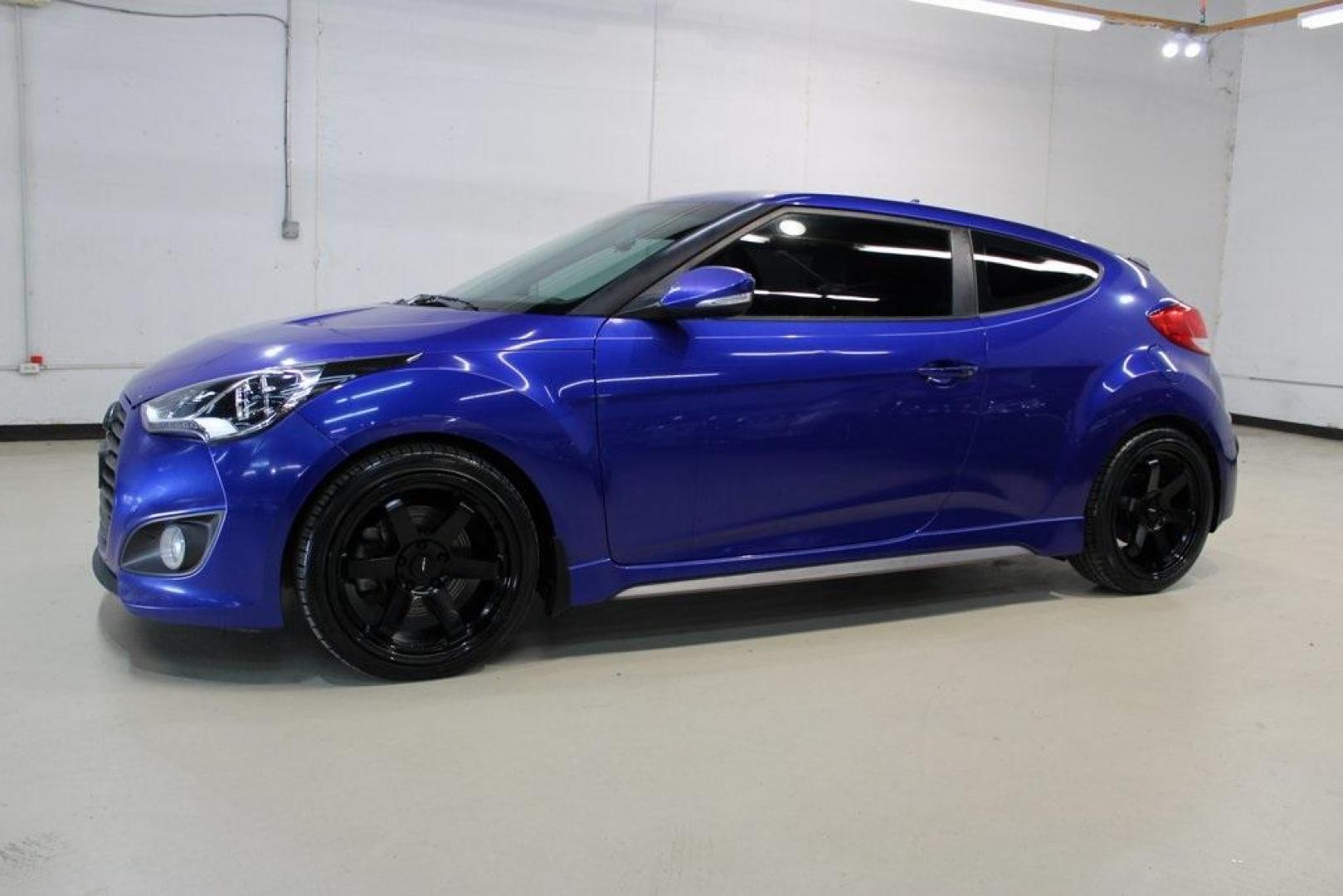 2014 Marathon Blue Pearl /Black Hyundai Veloster Turbo (KMHTC6AE7EU) with an 1.6L I4 DGI DOHC 16V Turbocharged engine, Manual transmission, located at 15300 Midway Rd., Addison, TX, 75001, (972) 702-0011, 32.958321, -96.838074 - HOME OF THE NO HAGGLE PRICE - WHOLESALE PRICES TO THE PUBLIC!! Veloster Turbo w/Black, 3D Hatchback, 1.6L I4 DGI DOHC 16V Turbocharged, 6-Speed Manual, FWD, Marathon Blue Pearl, Black Leather.<br><br>Marathon Blue Pearl 2014 Hyundai Veloster Turbo<br><br>Recent Arrival! 24/33 City/Highway MPG<br><br - Photo#4