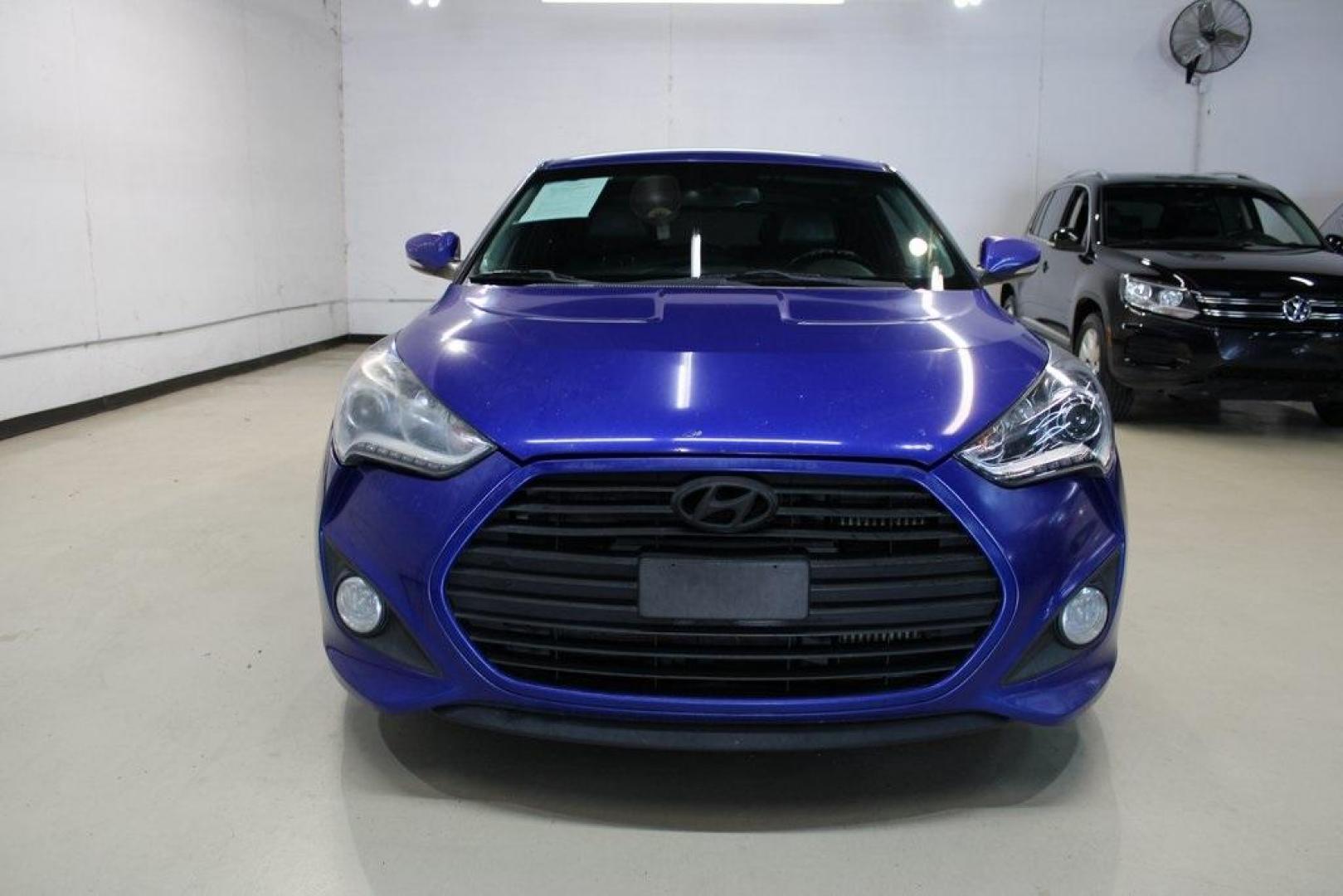 2014 Marathon Blue Pearl /Black Hyundai Veloster Turbo (KMHTC6AE7EU) with an 1.6L I4 DGI DOHC 16V Turbocharged engine, Manual transmission, located at 15300 Midway Rd., Addison, TX, 75001, (972) 702-0011, 32.958321, -96.838074 - HOME OF THE NO HAGGLE PRICE - WHOLESALE PRICES TO THE PUBLIC!! Veloster Turbo w/Black, 3D Hatchback, 1.6L I4 DGI DOHC 16V Turbocharged, 6-Speed Manual, FWD, Marathon Blue Pearl, Black Leather.<br><br>Marathon Blue Pearl 2014 Hyundai Veloster Turbo<br><br>Recent Arrival! 24/33 City/Highway MPG<br><br - Photo#5