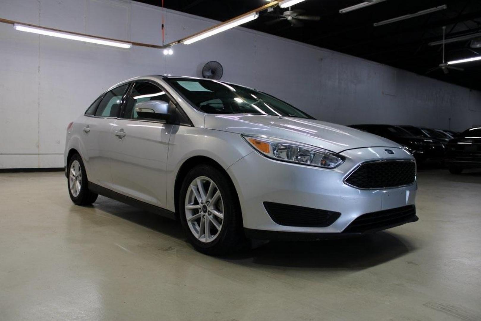 2016 Ingot Silver /Charcoal Black Ford Focus SE (1FADP3F27GL) with an I4 engine, Automatic transmission, located at 15300 Midway Rd., Addison, TX, 75001, (972) 702-0011, 32.958321, -96.838074 - HOME OF THE NO HAGGLE PRICE - WHOLESALE PRICES TO THE PUBLIC!! Focus SE, 4D Sedan, I4, 6-Speed Automatic with Powershift, FWD, Ingot Silver, Charcoal Black Cloth.<br><br>Ingot Silver 2016 Ford Focus SE<br><br>27/40 City/Highway MPG<br><br>Awards:<br> * 2016 KBB.com Brand Image Awards<br><br>At Midw - Photo#1