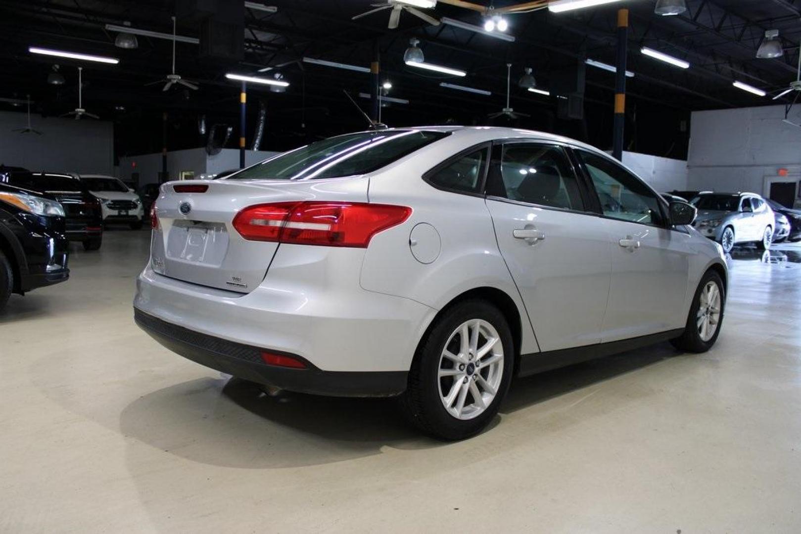 2016 Ingot Silver /Charcoal Black Ford Focus SE (1FADP3F27GL) with an I4 engine, Automatic transmission, located at 15300 Midway Rd., Addison, TX, 75001, (972) 702-0011, 32.958321, -96.838074 - HOME OF THE NO HAGGLE PRICE - WHOLESALE PRICES TO THE PUBLIC!! Focus SE, 4D Sedan, I4, 6-Speed Automatic with Powershift, FWD, Ingot Silver, Charcoal Black Cloth.<br><br>Ingot Silver 2016 Ford Focus SE<br><br>27/40 City/Highway MPG<br><br>Awards:<br> * 2016 KBB.com Brand Image Awards<br><br>At Midw - Photo#2