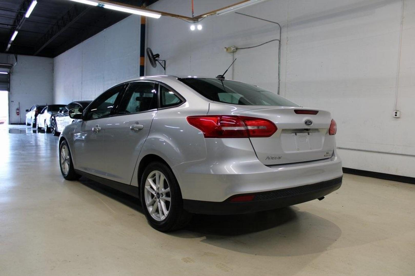 2016 Ingot Silver /Charcoal Black Ford Focus SE (1FADP3F27GL) with an I4 engine, Automatic transmission, located at 15300 Midway Rd., Addison, TX, 75001, (972) 702-0011, 32.958321, -96.838074 - HOME OF THE NO HAGGLE PRICE - WHOLESALE PRICES TO THE PUBLIC!! Focus SE, 4D Sedan, I4, 6-Speed Automatic with Powershift, FWD, Ingot Silver, Charcoal Black Cloth.<br><br>Ingot Silver 2016 Ford Focus SE<br><br>27/40 City/Highway MPG<br><br>Awards:<br> * 2016 KBB.com Brand Image Awards<br><br>At Midw - Photo#3