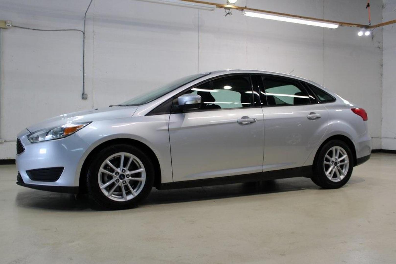 2016 Ingot Silver /Charcoal Black Ford Focus SE (1FADP3F27GL) with an I4 engine, Automatic transmission, located at 15300 Midway Rd., Addison, TX, 75001, (972) 702-0011, 32.958321, -96.838074 - HOME OF THE NO HAGGLE PRICE - WHOLESALE PRICES TO THE PUBLIC!! Focus SE, 4D Sedan, I4, 6-Speed Automatic with Powershift, FWD, Ingot Silver, Charcoal Black Cloth.<br><br>Ingot Silver 2016 Ford Focus SE<br><br>27/40 City/Highway MPG<br><br>Awards:<br> * 2016 KBB.com Brand Image Awards<br><br>At Midw - Photo#4