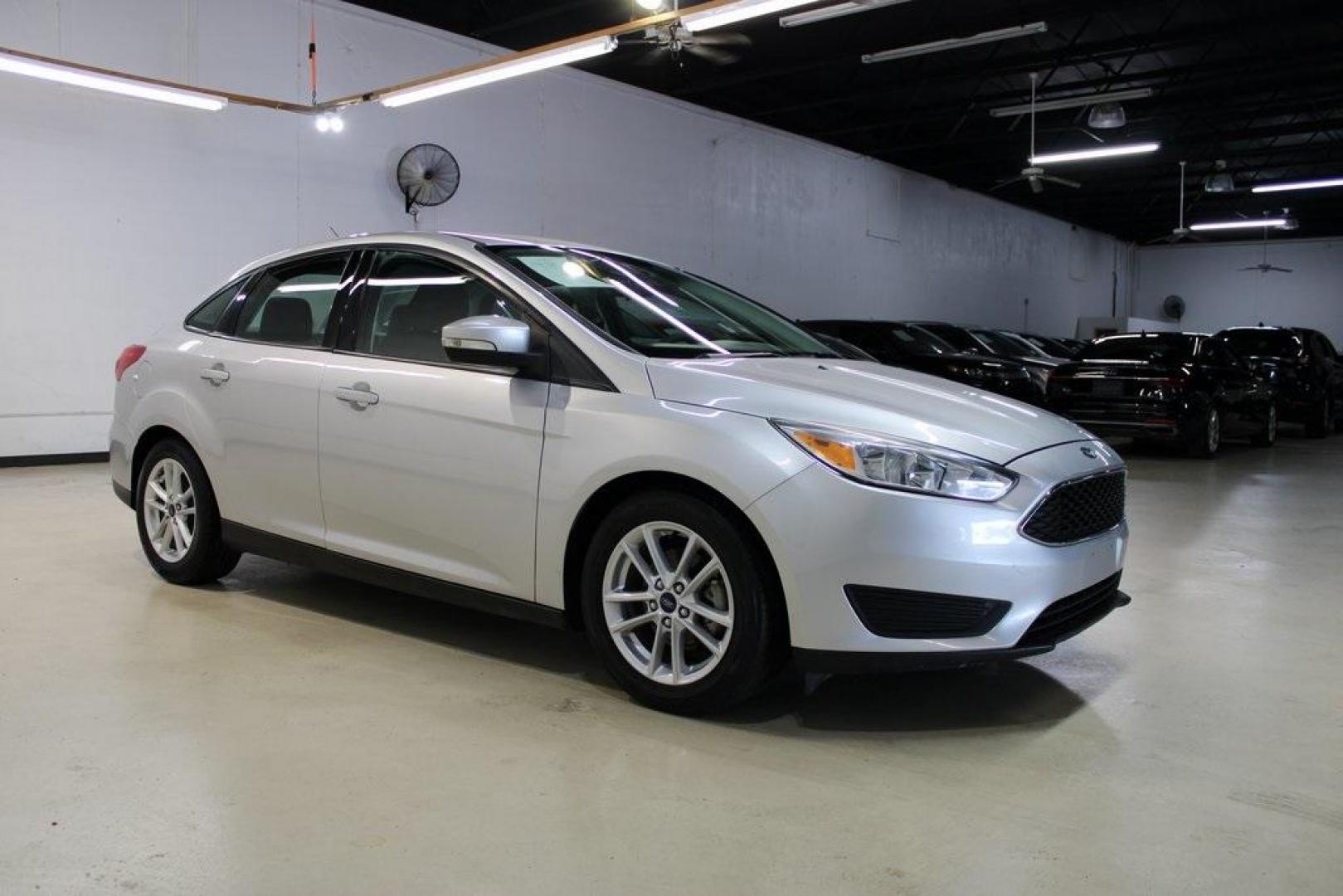 2016 Ingot Silver /Charcoal Black Ford Focus SE (1FADP3F27GL) with an I4 engine, Automatic transmission, located at 15300 Midway Rd., Addison, TX, 75001, (972) 702-0011, 32.958321, -96.838074 - HOME OF THE NO HAGGLE PRICE - WHOLESALE PRICES TO THE PUBLIC!! Focus SE, 4D Sedan, I4, 6-Speed Automatic with Powershift, FWD, Ingot Silver, Charcoal Black Cloth.<br><br>Ingot Silver 2016 Ford Focus SE<br><br>27/40 City/Highway MPG<br><br>Awards:<br> * 2016 KBB.com Brand Image Awards<br><br>At Midw - Photo#6