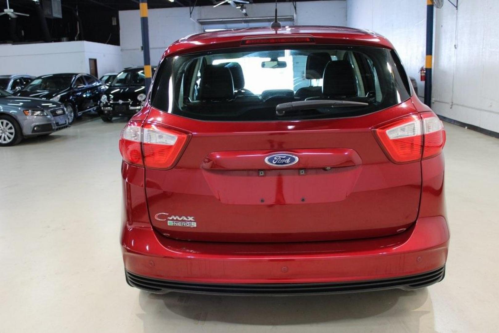 2014 Ruby Red Metallic Tinted Clearcoat /Charcoal Black Ford C-Max Energi SEL (1FADP5CU2EL) with an 2.0L I4 Atkinson-Cycle Hybrid engine, CVT transmission, located at 15300 Midway Rd., Addison, TX, 75001, (972) 702-0011, 32.958321, -96.838074 - HOME OF THE NO HAGGLE PRICE - WHOLESALE PRICES TO THE PUBLIC!! C-Max Energi SEL, 4D Hatchback, 2.0L I4 Atkinson-Cycle Hybrid, CVT, FWD, Red, Charcoal Black Leather.<br><br>Red 2014 Ford C-Max Energi SEL<br><br>Recent Arrival! 40/36 City/Highway MPG<br><br>Awards:<br> * 2014 KBB.com Brand Image Awar - Photo#5