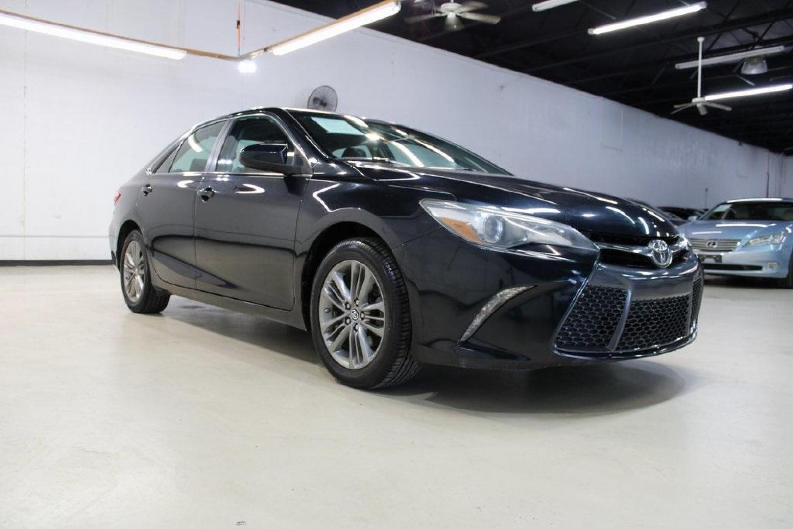 2016 Midnight Black Metallic /Ash/Black Toyota Camry SE (4T1BF1FK4GU) with an 2.5L I4 SMPI DOHC engine, Automatic transmission, located at 15300 Midway Rd., Addison, TX, 75001, (972) 702-0011, 32.958321, -96.838074 - HOME OF THE NO HAGGLE PRICE - WHOLESALE PRICES TO THE PUBLIC!! Camry SE, 4D Sedan, 2.5L I4 SMPI DOHC, 6-Speed Automatic, FWD, Ash/Black Cloth.<br><br>Midnight Black Metallic 2016 Toyota Camry SE<br><br>25/35 City/Highway MPG<br><br>Awards:<br> * 2016 KBB.com 10 Most Awarded Cars * 2016 KBB.com 5- - Photo#1