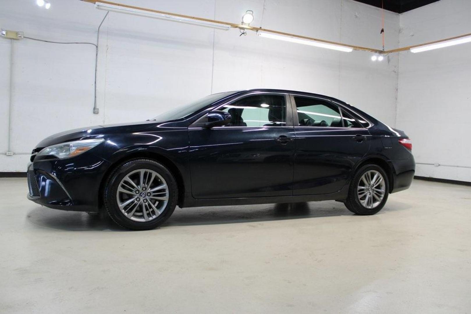 2016 Midnight Black Metallic /Ash/Black Toyota Camry SE (4T1BF1FK4GU) with an 2.5L I4 SMPI DOHC engine, Automatic transmission, located at 15300 Midway Rd., Addison, TX, 75001, (972) 702-0011, 32.958321, -96.838074 - HOME OF THE NO HAGGLE PRICE - WHOLESALE PRICES TO THE PUBLIC!! Camry SE, 4D Sedan, 2.5L I4 SMPI DOHC, 6-Speed Automatic, FWD, Ash/Black Cloth.<br><br>Midnight Black Metallic 2016 Toyota Camry SE<br><br>25/35 City/Highway MPG<br><br>Awards:<br> * 2016 KBB.com 10 Most Awarded Cars * 2016 KBB.com 5- - Photo#4