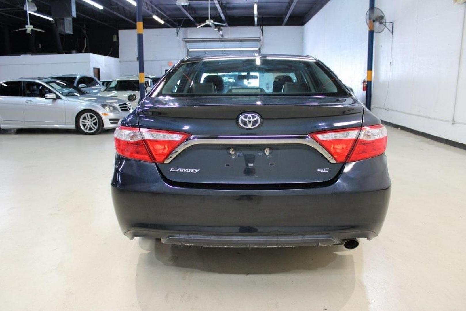 2016 Midnight Black Metallic /Ash/Black Toyota Camry SE (4T1BF1FK4GU) with an 2.5L I4 SMPI DOHC engine, Automatic transmission, located at 15300 Midway Rd., Addison, TX, 75001, (972) 702-0011, 32.958321, -96.838074 - HOME OF THE NO HAGGLE PRICE - WHOLESALE PRICES TO THE PUBLIC!! Camry SE, 4D Sedan, 2.5L I4 SMPI DOHC, 6-Speed Automatic, FWD, Ash/Black Cloth.<br><br>Midnight Black Metallic 2016 Toyota Camry SE<br><br>25/35 City/Highway MPG<br><br>Awards:<br> * 2016 KBB.com 10 Most Awarded Cars * 2016 KBB.com 5- - Photo#7