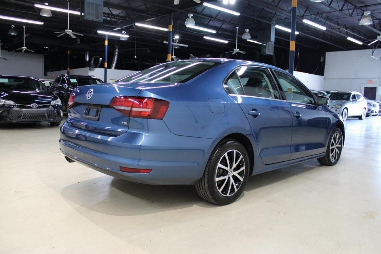 2017 Silk Blue Metallic Volkswagen Jetta 1.4T SE (3VWDB7AJXHM) with an 1.4L TSI engine, Automatic transmission, located at 15300 Midway Rd., Addison, TX, 75001, (972) 702-0011, 32.958321, -96.838074 - HOME OF THE NO HAGGLE PRICE - WHOLESALE PRICES TO THE PUBLIC!!<br><br>Blue 2017 Volkswagen Jetta 1.4T SE<br><br>Recent Arrival! 28/38 City/Highway MPG<br><br>Awards:<br> * 2017 IIHS Top Safety Pick+ * 2017 KBB.com 10 Coolest New Cars Under $18,000 * 2017 KBB.com 10 Best Used Compact Cars Under - Photo#2