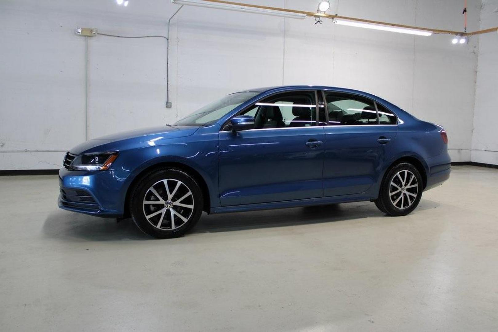 2017 Silk Blue Metallic Volkswagen Jetta 1.4T SE (3VWDB7AJXHM) with an 1.4L TSI engine, Automatic transmission, located at 15300 Midway Rd., Addison, TX, 75001, (972) 702-0011, 32.958321, -96.838074 - HOME OF THE NO HAGGLE PRICE - WHOLESALE PRICES TO THE PUBLIC!!<br><br>Blue 2017 Volkswagen Jetta 1.4T SE<br><br>Recent Arrival! 28/38 City/Highway MPG<br><br>Awards:<br> * 2017 IIHS Top Safety Pick+ * 2017 KBB.com 10 Coolest New Cars Under $18,000 * 2017 KBB.com 10 Best Used Compact Cars Under - Photo#4