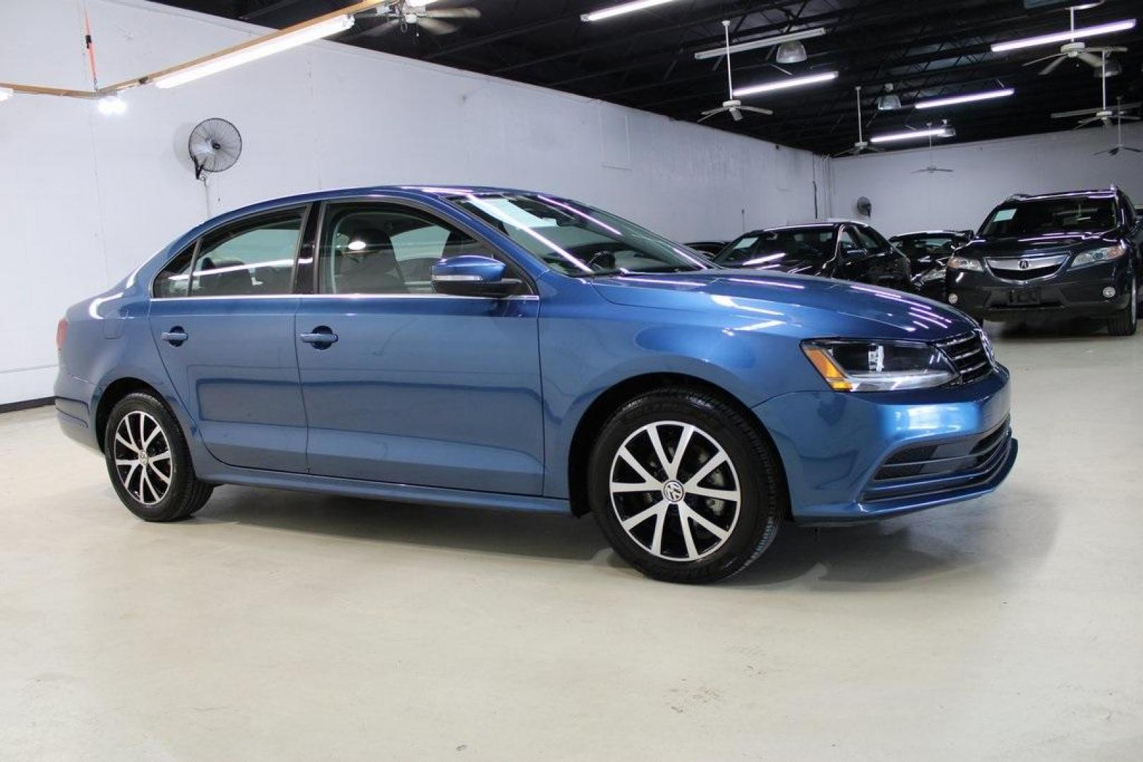 2017 Silk Blue Metallic Volkswagen Jetta 1.4T SE (3VWDB7AJXHM) with an 1.4L TSI engine, Automatic transmission, located at 15300 Midway Rd., Addison, TX, 75001, (972) 702-0011, 32.958321, -96.838074 - HOME OF THE NO HAGGLE PRICE - WHOLESALE PRICES TO THE PUBLIC!!<br><br>Blue 2017 Volkswagen Jetta 1.4T SE<br><br>Recent Arrival! 28/38 City/Highway MPG<br><br>Awards:<br> * 2017 IIHS Top Safety Pick+ * 2017 KBB.com 10 Coolest New Cars Under $18,000 * 2017 KBB.com 10 Best Used Compact Cars Under - Photo#6