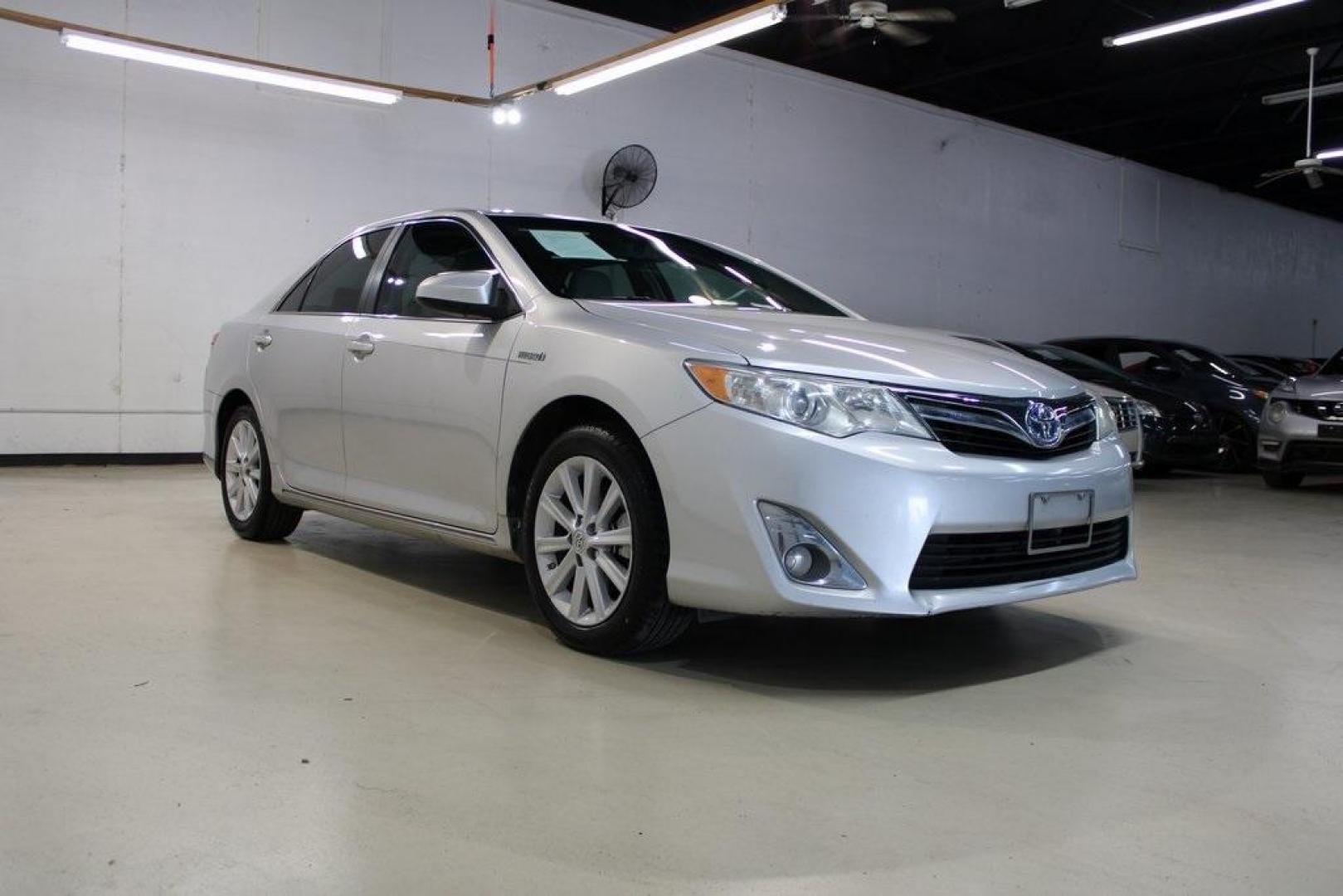 2012 Classic Silver Metallic /Ivory Toyota Camry Hybrid XLE (4T1BD1FK6CU) with an 2.5L I4 Hybrid DOHC engine, CVT transmission, located at 15300 Midway Rd., Addison, TX, 75001, (972) 702-0011, 32.958321, -96.838074 - HOME OF THE NO HAGGLE PRICE - WHOLESALE PRICES TO THE PUBLIC!! Camry Hybrid XLE, 4D Sedan, 2.5L I4 Hybrid DOHC, eCVT, FWD, Silver, Cloth.<br><br>Silver 2012 Toyota Camry Hybrid XLE<br><br>Recent Arrival! 40/38 City/Highway MPG<br><br>Awards:<br> * 2012 KBB.com Best Resale Value Awards<br><br>At Mid - Photo#1