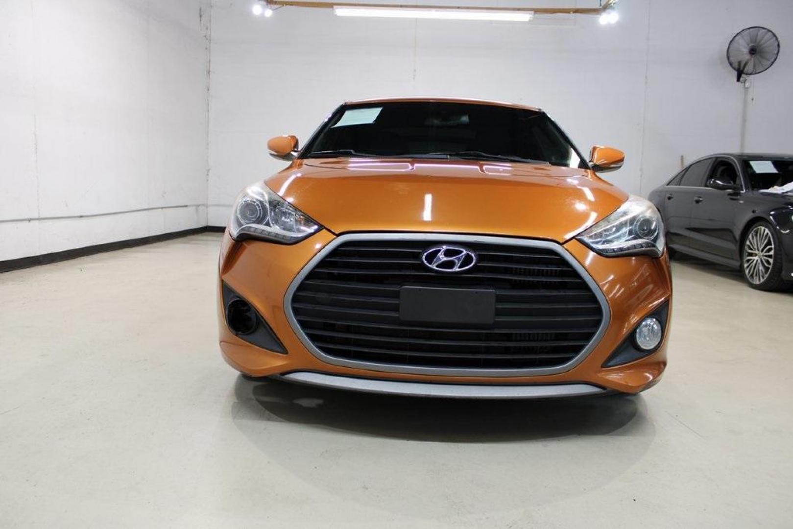 2016 Vitamin C Pearl /Black Hyundai Veloster Turbo (KMHTC6AE8GU) with an I4 engine, Automatic transmission, located at 15300 Midway Rd., Addison, TX, 75001, (972) 702-0011, 32.958321, -96.838074 - HOME OF THE NO HAGGLE PRICE - WHOLESALE PRICES TO THE PUBLIC!! Veloster Turbo, 3D Hatchback, I4, 7-Speed EcoShift Dual Clutch, FWD, Vitamin C Pearl, Black Leather.<br><br>Vitamin C Pearl 2016 Hyundai Veloster Turbo<br><br>27/33 City/Highway MPG<br><br>Awards:<br> * 2016 KBB.com 10 Coolest New Cars - Photo#5