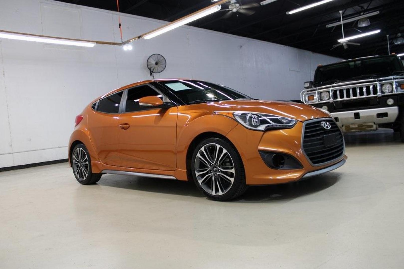 2016 Vitamin C Pearl /Black Hyundai Veloster Turbo (KMHTC6AE8GU) with an I4 engine, Automatic transmission, located at 15300 Midway Rd., Addison, TX, 75001, (972) 702-0011, 32.958321, -96.838074 - HOME OF THE NO HAGGLE PRICE - WHOLESALE PRICES TO THE PUBLIC!! Veloster Turbo, 3D Hatchback, I4, 7-Speed EcoShift Dual Clutch, FWD, Vitamin C Pearl, Black Leather.<br><br>Vitamin C Pearl 2016 Hyundai Veloster Turbo<br><br>27/33 City/Highway MPG<br><br>Awards:<br> * 2016 KBB.com 10 Coolest New Cars - Photo#6