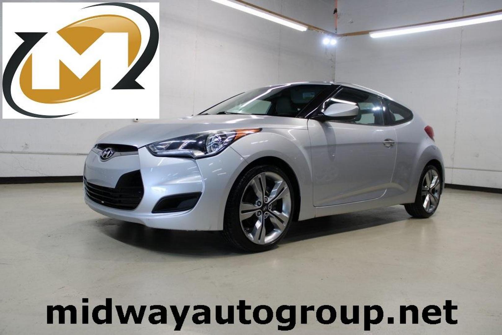 2012 Ironman Silver /Gray Hyundai Veloster Base (KMHTC6AD0CU) with an 1.6L 4-Cylinder DGI DOHC engine, Automatic transmission, located at 15300 Midway Rd., Addison, TX, 75001, (972) 702-0011, 32.958321, -96.838074 - HOME OF THE NO HAGGLE PRICE - WHOLESALE PRICES TO THE PUBLIC!! 3D Hatchback, 1.6L 4-Cylinder DGI DOHC, 6-Speed Automatic, FWD, Ironman Silver, Gray Cloth.<br><br>Ironman Silver 2012 Hyundai Veloster<br><br>27/35 City/Highway MPG<br><br>Awards:<br> * 2012 KBB.com 10 Coolest New Cars Under $18,000<br - Photo#0