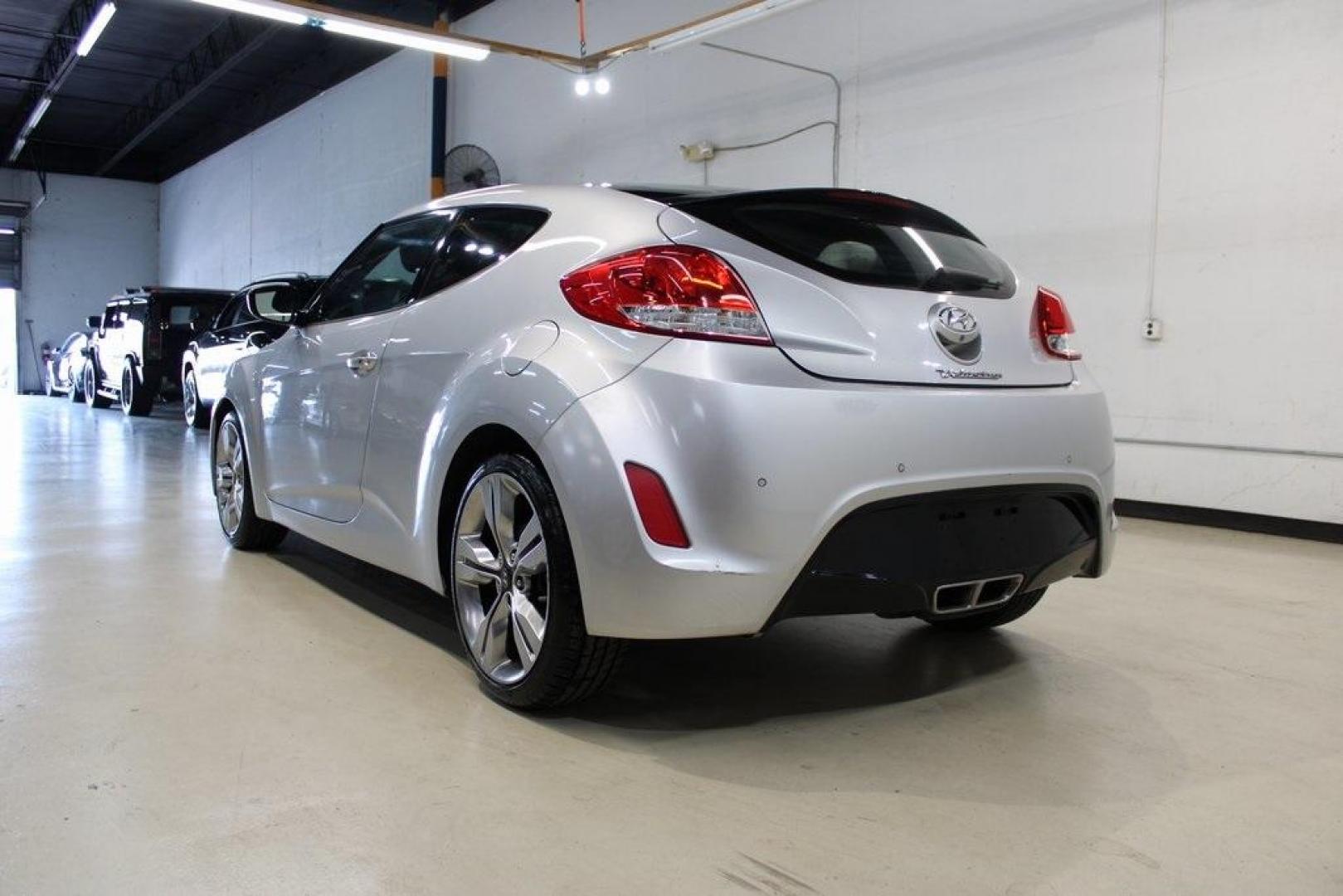 2012 Ironman Silver /Gray Hyundai Veloster Base (KMHTC6AD0CU) with an 1.6L 4-Cylinder DGI DOHC engine, Automatic transmission, located at 15300 Midway Rd., Addison, TX, 75001, (972) 702-0011, 32.958321, -96.838074 - HOME OF THE NO HAGGLE PRICE - WHOLESALE PRICES TO THE PUBLIC!! 3D Hatchback, 1.6L 4-Cylinder DGI DOHC, 6-Speed Automatic, FWD, Ironman Silver, Gray Cloth.<br><br>Ironman Silver 2012 Hyundai Veloster<br><br>27/35 City/Highway MPG<br><br>Awards:<br> * 2012 KBB.com 10 Coolest New Cars Under $18,000<br - Photo#3