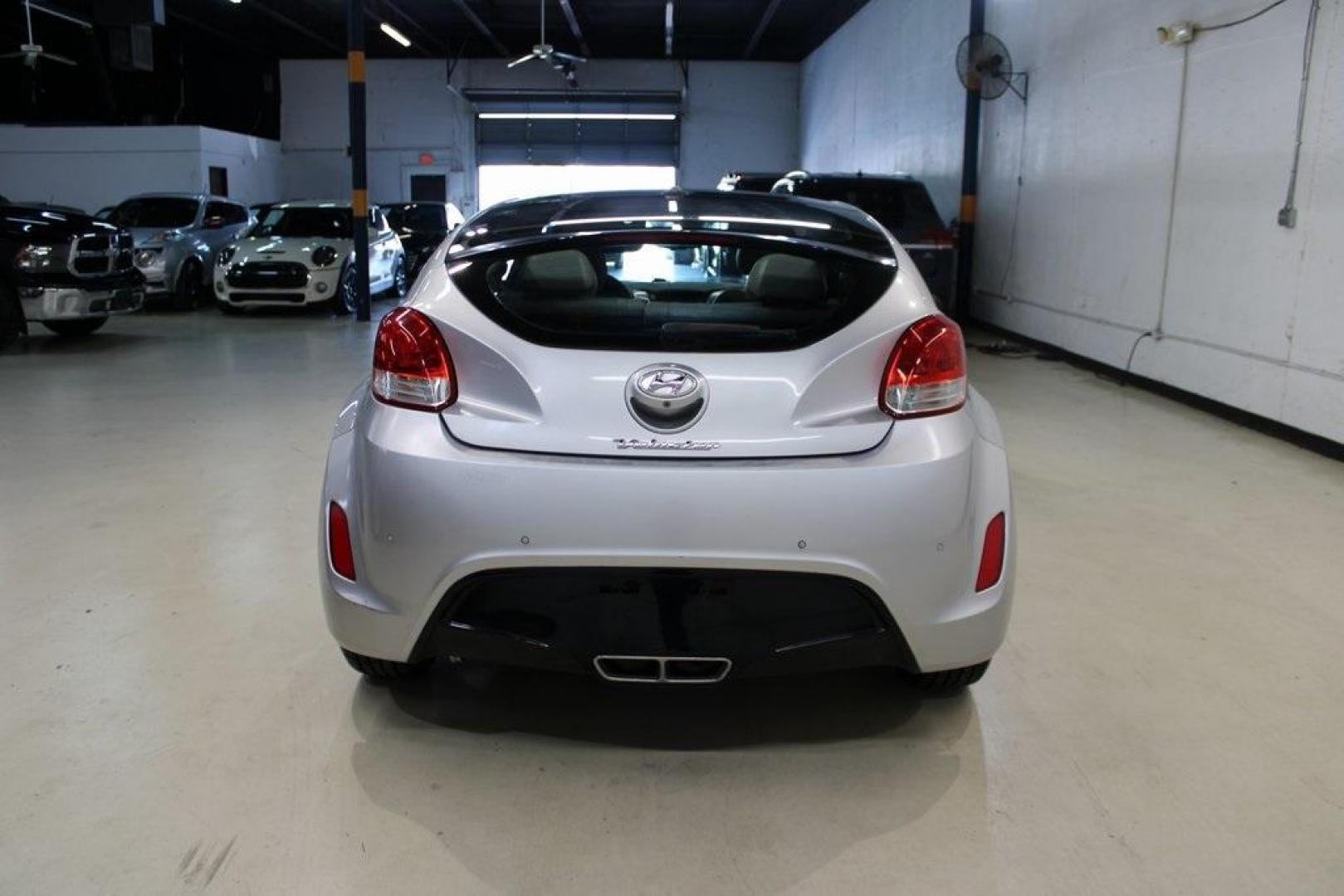 2012 Ironman Silver /Gray Hyundai Veloster Base (KMHTC6AD0CU) with an 1.6L 4-Cylinder DGI DOHC engine, Automatic transmission, located at 15300 Midway Rd., Addison, TX, 75001, (972) 702-0011, 32.958321, -96.838074 - HOME OF THE NO HAGGLE PRICE - WHOLESALE PRICES TO THE PUBLIC!! 3D Hatchback, 1.6L 4-Cylinder DGI DOHC, 6-Speed Automatic, FWD, Ironman Silver, Gray Cloth.<br><br>Ironman Silver 2012 Hyundai Veloster<br><br>27/35 City/Highway MPG<br><br>Awards:<br> * 2012 KBB.com 10 Coolest New Cars Under $18,000<br - Photo#7