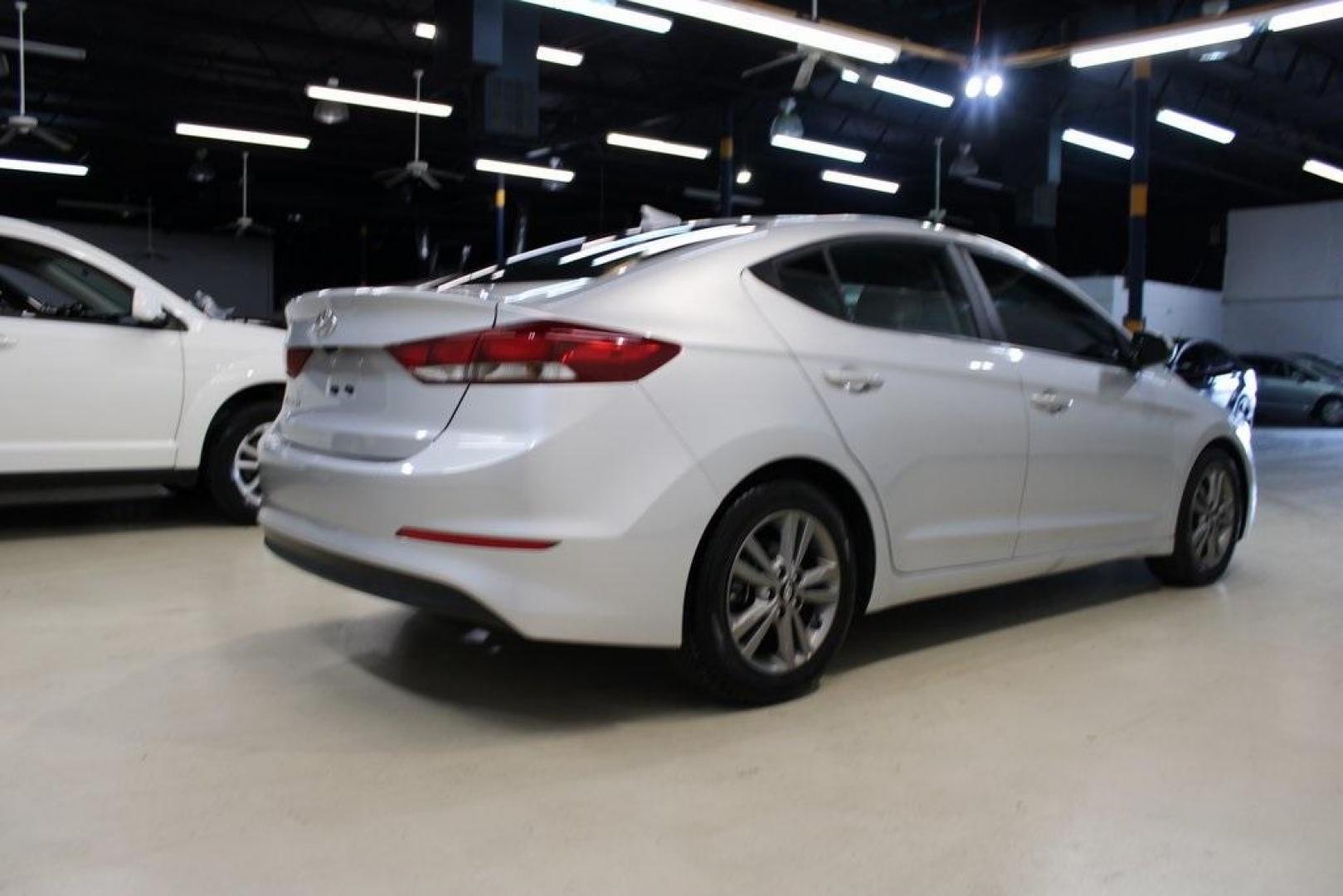 2018 Symphony Silver /Gray Hyundai Elantra SEL (5NPD84LF1JH) with an 2.0L 4-Cylinder DOHC 16V engine, Automatic transmission, located at 15300 Midway Rd., Addison, TX, 75001, (972) 702-0011, 32.958321, -96.838074 - HOME OF THE NO HAGGLE PRICE - WHOLESALE PRICES TO THE PUBLIC!! Elantra SEL, 4D Sedan, 2.0L 4-Cylinder DOHC 16V, 6-Speed Automatic with Shiftronic, FWD, Symphony Silver, Gray Cloth.<br><br>Symphony Silver 2018 Hyundai Elantra SEL<br><br>Recent Arrival! 28/37 City/Highway MPG<br><br>Awards:<br> * 201 - Photo#2