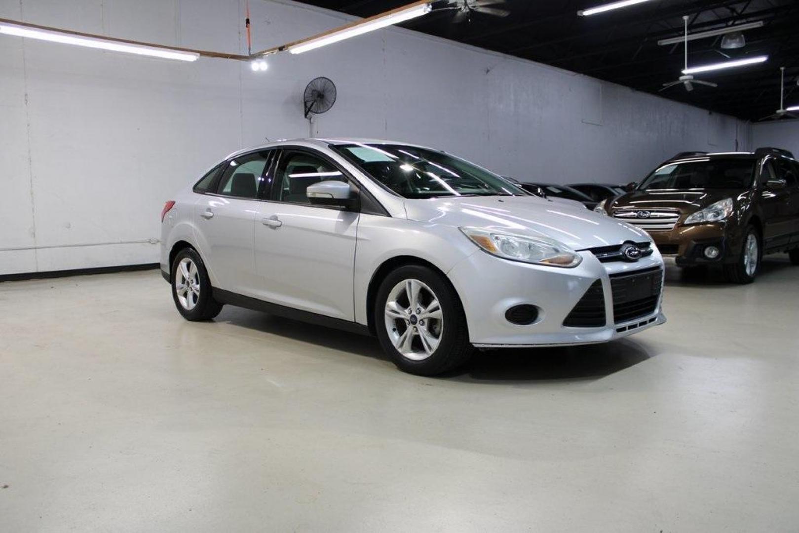 2014 Ingot Silver Metallic /Charcoal/Tangerine Scream Ford Focus SE (1FADP3F28EL) with an I4 engine, Automatic transmission, located at 15300 Midway Rd., Addison, TX, 75001, (972) 702-0011, 32.958321, -96.838074 - HOME OF THE NO HAGGLE PRICE - WHOLESALE PRICES TO THE PUBLIC!! Focus SE, 4D Sedan, I4, FWD, Silver, Charcoal/Tangerine Scream Cloth. Odometer is 60508 miles below market average!<br><br>Silver 2014 Ford Focus SE<br><br>26/36 City/Highway MPG<br><br>Awards:<br> * 2014 IIHS Top Safety Pick * 2014 K - Photo#6