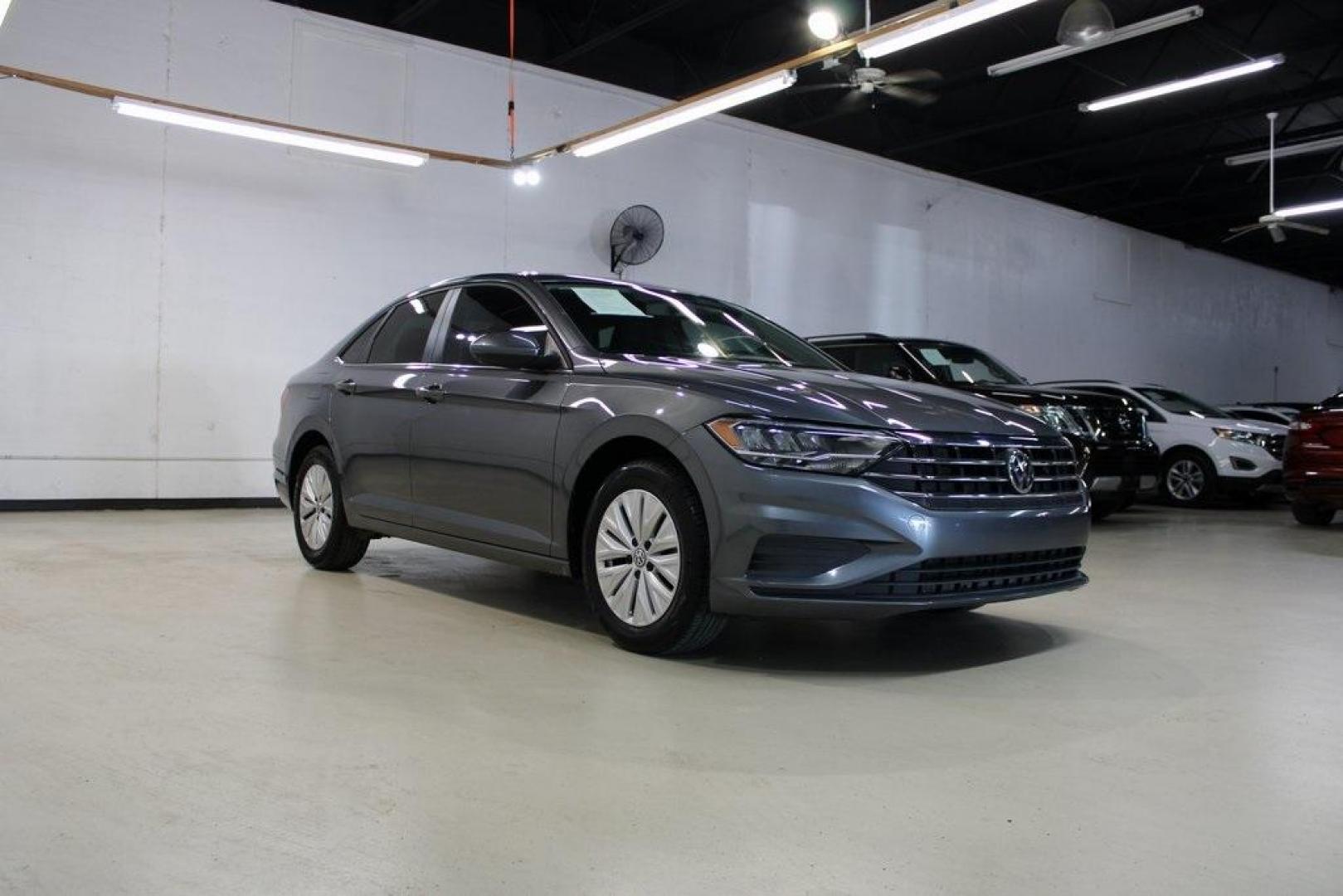 2019 Platinum Gray Metallic /Storm Gray Volkswagen Jetta 1.4T S (3VWC57BU4KM) with an 1.4L TSI engine, Automatic transmission, located at 15300 Midway Rd., Addison, TX, 75001, (972) 702-0011, 32.958321, -96.838074 - HOME OF THE NO HAGGLE PRICE - WHOLESALE PRICES TO THE PUBLIC!! non smoker, Jetta 1.4T S, 4D Sedan, 1.4L TSI, 8-Speed Automatic with Tiptronic, FWD, Gray.<br><br>Gray 2019 Volkswagen Jetta 1.4T S<br><br>Recent Arrival! 30/40 City/Highway MPG<br><br>Awards:<br> * 2019 KBB.com 10 Best Sedans Under $30 - Photo#1