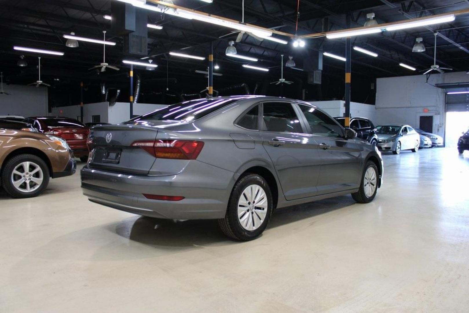 2019 Platinum Gray Metallic /Storm Gray Volkswagen Jetta 1.4T S (3VWC57BU4KM) with an 1.4L TSI engine, Automatic transmission, located at 15300 Midway Rd., Addison, TX, 75001, (972) 702-0011, 32.958321, -96.838074 - HOME OF THE NO HAGGLE PRICE - WHOLESALE PRICES TO THE PUBLIC!! non smoker, Jetta 1.4T S, 4D Sedan, 1.4L TSI, 8-Speed Automatic with Tiptronic, FWD, Gray.<br><br>Gray 2019 Volkswagen Jetta 1.4T S<br><br>Recent Arrival! 30/40 City/Highway MPG<br><br>Awards:<br> * 2019 KBB.com 10 Best Sedans Under $30 - Photo#2