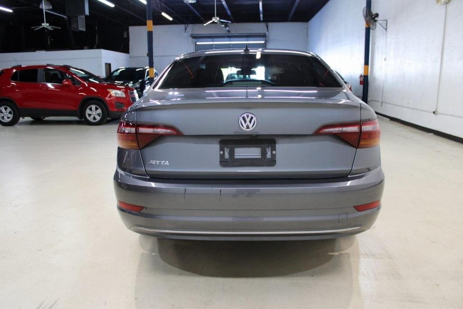 2019 Platinum Gray Metallic /Storm Gray Volkswagen Jetta 1.4T S (3VWC57BU4KM) with an 1.4L TSI engine, Automatic transmission, located at 15300 Midway Rd., Addison, TX, 75001, (972) 702-0011, 32.958321, -96.838074 - HOME OF THE NO HAGGLE PRICE - WHOLESALE PRICES TO THE PUBLIC!! non smoker, Jetta 1.4T S, 4D Sedan, 1.4L TSI, 8-Speed Automatic with Tiptronic, FWD, Gray.<br><br>Gray 2019 Volkswagen Jetta 1.4T S<br><br>Recent Arrival! 30/40 City/Highway MPG<br><br>Awards:<br> * 2019 KBB.com 10 Best Sedans Under $30 - Photo#4