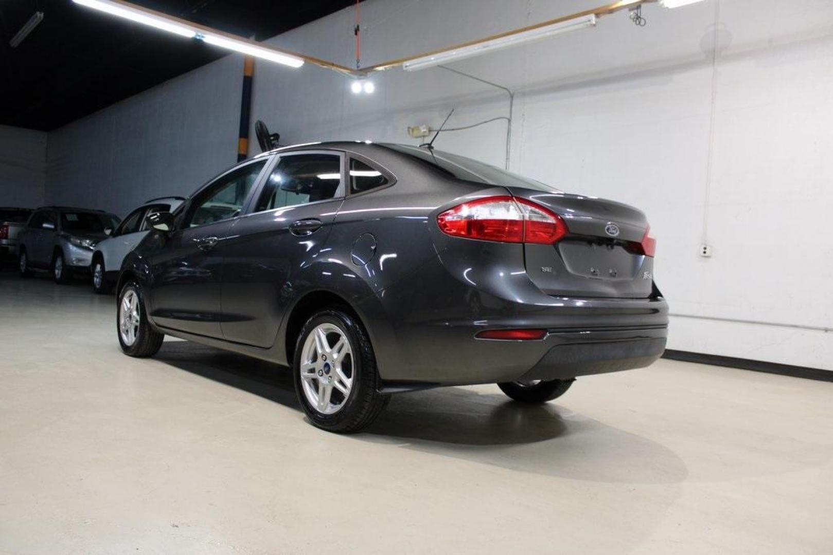 2019 Magnetic /Charcoal Black Ford Fiesta SE (3FADP4BJ1KM) with an 1.6L I4 Ti-VCT engine, Automatic transmission, located at 15300 Midway Rd., Addison, TX, 75001, (972) 702-0011, 32.958321, -96.838074 - Photo#2