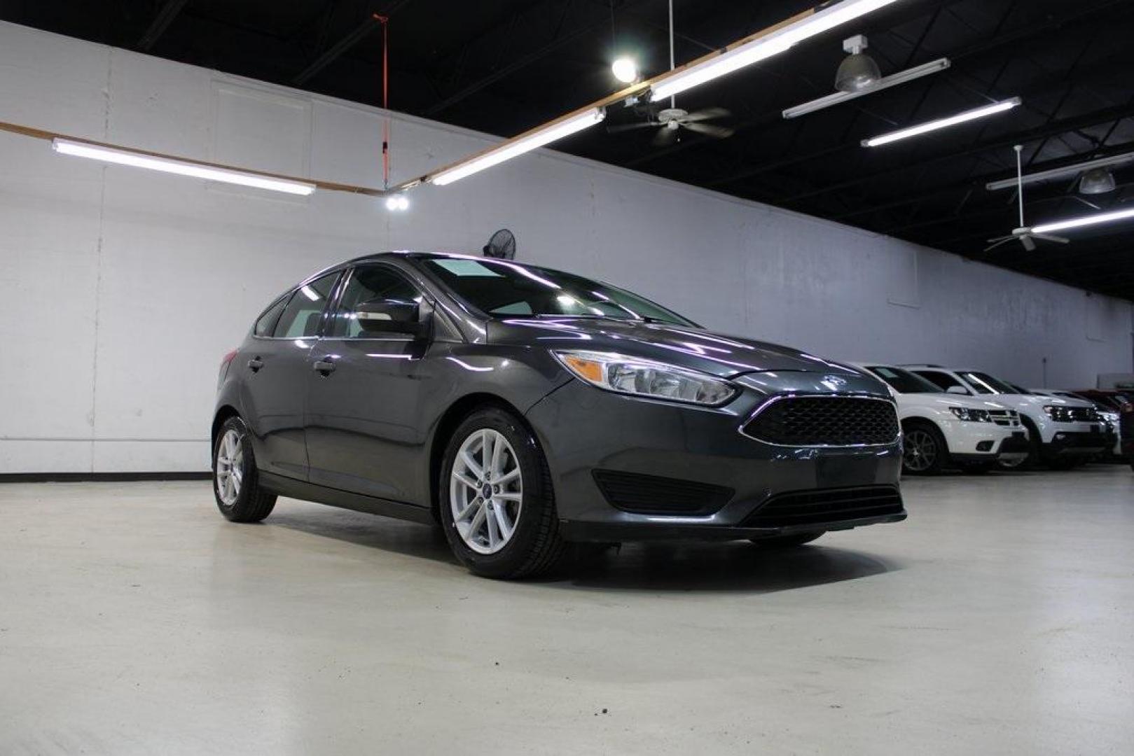 2017 Magnetic /Charcoal Black Ford Focus SE (1FADP3K21HL) with an 2.0L 4-Cylinder DGI Flex Fuel DOHC engine, Automatic transmission, located at 15300 Midway Rd., Addison, TX, 75001, (972) 702-0011, 32.958321, -96.838074 - Photo#1