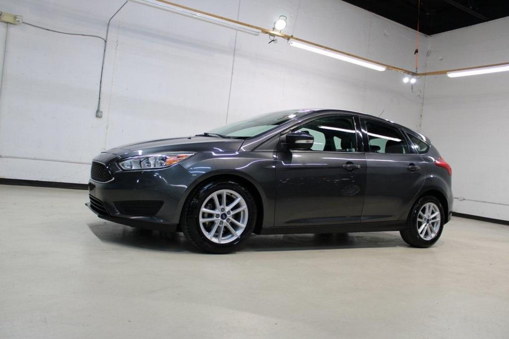 2017 Magnetic /Charcoal Black Ford Focus SE (1FADP3K21HL) with an 2.0L 4-Cylinder DGI Flex Fuel DOHC engine, Automatic transmission, located at 15300 Midway Rd., Addison, TX, 75001, (972) 702-0011, 32.958321, -96.838074 - Photo#4