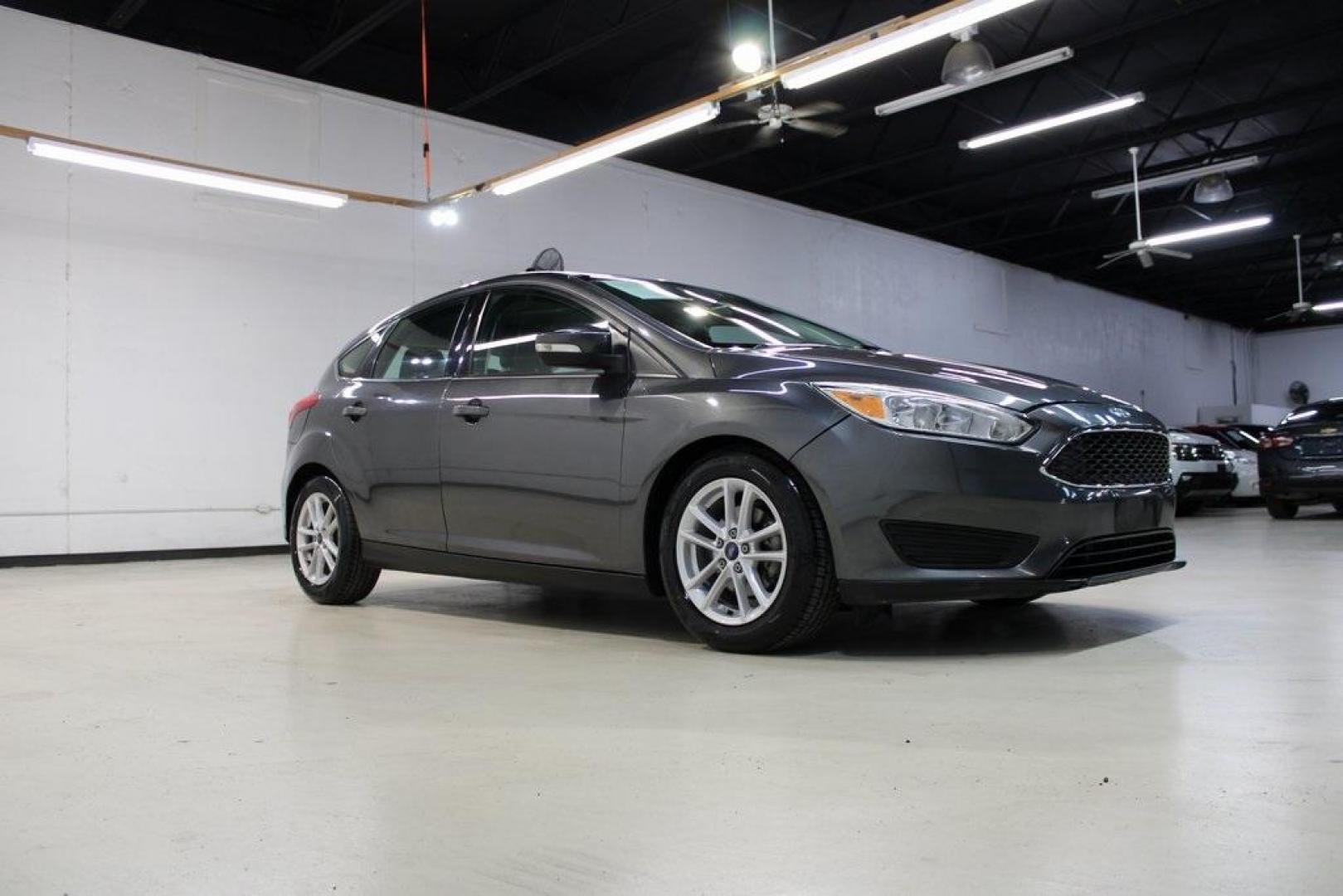 2017 Magnetic /Charcoal Black Ford Focus SE (1FADP3K21HL) with an 2.0L 4-Cylinder DGI Flex Fuel DOHC engine, Automatic transmission, located at 15300 Midway Rd., Addison, TX, 75001, (972) 702-0011, 32.958321, -96.838074 - Photo#6