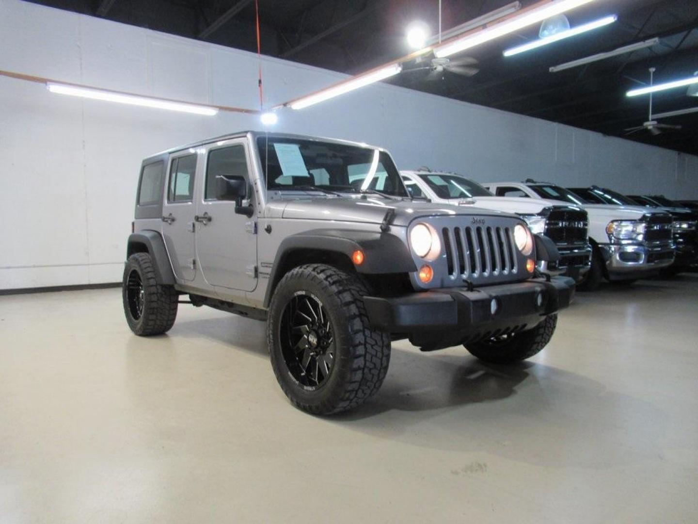 2018 Billet Silver Metallic Clearcoat /Black Jeep Wrangler JK Unlimited Sport (1C4BJWDG6JL) with an 3.6L V6 24V VVT engine, Automatic transmission, located at 15300 Midway Rd., Addison, TX, 75001, (972) 702-0011, 32.958321, -96.838074 - HOME OF THE NO HAGGLE PRICE - WHOLESALE PRICES TO THE PUBLIC!! 4D Sport Utility, 3.6L V6 24V VVT, 4WD, Silver, ABS brakes, Compass, Electronic Stability Control, Low tire pressure warning, Traction control.<br><br>Silver 2018 Jeep Wrangler JK Unlimited Sport<br><br>Recent Arrival!<br><br>Awards:<br> - Photo#1